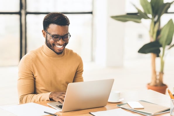 man using a laptop to read a CSS tutorial